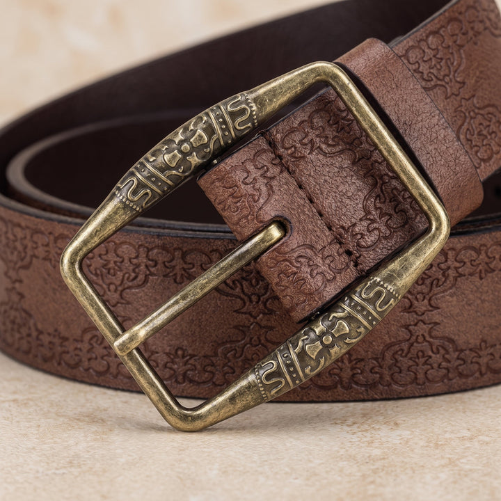 Close-up of the antique brass buckle and embossed scrollwork on the Drayton Belt