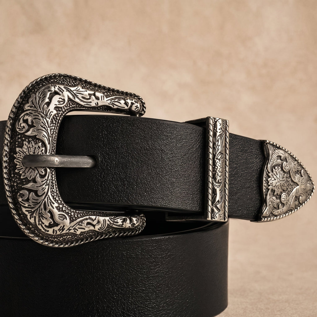 Close-up of the engraved silver-tone buckle, keeper and tip of the Merle Belt