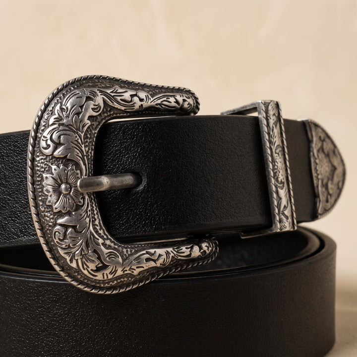 Detail of the smooth black strap and floral engraving on the Merle Belt